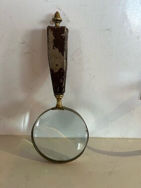 Vintage handheld leather embossed and brass magnifying glass.